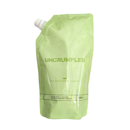 The Uncrumpled refill pouch, a 500ml light green resealable stand-up pouch with a white screw cap, isolated on a white background.